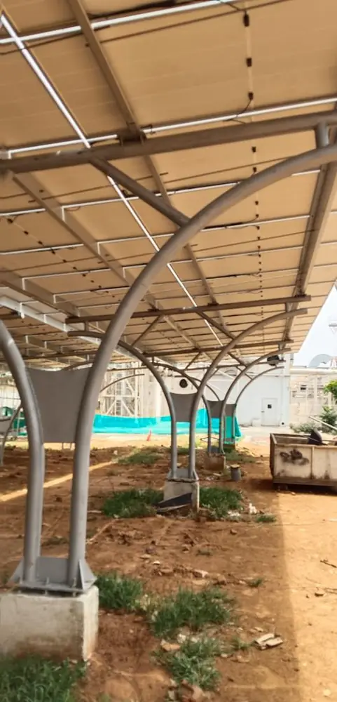 A completed carport bay with modules overhead and curved support columns